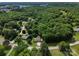 Expansive aerial view of a property surrounded by lush green trees and serene countryside at 10672 Barberville Rd, Fort Mill, SC 29707