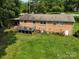 Aerial view of brick home back with a deck and spacious lawn at 10672 Barberville Rd, Fort Mill, SC 29707