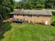 Aerial view of brick home back with a deck and spacious lawn at 10672 Barberville Rd, Fort Mill, SC 29707