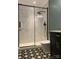 Modern bathroom features glass enclosed shower with black trim, and black and white patterned tile flooring at 10672 Barberville Rd, Fort Mill, SC 29707