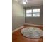 This bedroom features a gray shag rug, hardwood floors and two windows at 10672 Barberville Rd, Fort Mill, SC 29707
