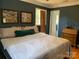 Cozy bedroom features an ensuite bathroom, a plush bed, hardwood floors, and soft, natural lighting at 10672 Barberville Rd, Fort Mill, SC 29707
