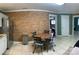 Bright dining area with a brick accent wall, tiled floors, and a cozy dining table and chairs at 10672 Barberville Rd, Fort Mill, SC 29707