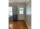 Charming entryway featuring hardwood floors, a bright window, and a classic white door with glass panes at 10672 Barberville Rd, Fort Mill, SC 29707