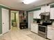 Cozy kitchen featuring white cabinets, stainless steel appliances, and a brick accent wall for added charm at 10672 Barberville Rd, Fort Mill, SC 29707