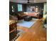 Spacious living room showcases hardwood floors, a stylish leather sofa, and a rustic wooden chest coffee table at 10672 Barberville Rd, Fort Mill, SC 29707