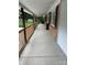 Long covered front porch with new wood railing, brick accents and access to a hanging chair at 10672 Barberville Rd, Fort Mill, SC 29707