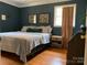Comfortable bedroom features hardwood floors, modern wall art, and lots of light at 10672 Barberville Rd, Indian Land, SC 29707