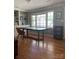 Bright office with built-in shelving, hardwood floors, and a large table perfect for work at 10672 Barberville Rd, Indian Land, SC 29707