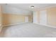 A charming bedroom with neutral carpet, paint, white trim, and two large doors at 108 Forrester Ave, Belmont, NC 28012