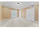 Spacious bedroom with neutral paint, white trim, a door to a porch, and two large doors at 108 Forrester Ave, Belmont, NC 28012