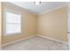 Bright bedroom with neutral carpet, large window, and ample natural light at 108 Forrester Ave, Belmont, NC 28012