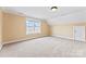 A charming bedroom with neutral carpet, paint, white trim, and plenty of natural light from a large window at 108 Forrester Ave, Belmont, NC 28012