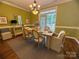 Sunlit dining room featuring hardwood floors, a modern chandelier, and ample seating for six at 108 Forrester Ave, Belmont, NC 28012