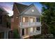 Striking nighttime view of a brick home with double porches, showing the architectural details and curb appeal at 108 Forrester Ave, Belmont, NC 28012