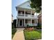 Charming brick home showcasing double porches, complemented by professional landscaping and a manicured lawn at 108 Forrester Ave, Belmont, NC 28012