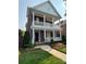 Attractive brick home boasting double porches, complemented by vibrant landscaping and a well-manicured lawn at 108 Forrester Ave, Belmont, NC 28012