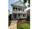 Charming brick home showcasing double porches, complemented by professional landscaping and a manicured lawn at 108 Forrester Ave, Belmont, NC 28012