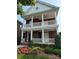 Stately brick home featuring double porches with white railings, offering charming curb appeal and classic design at 108 Forrester Ave, Belmont, NC 28012