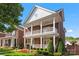 Charming brick home featuring a double front porch, manicured landscaping, and a welcoming facade at 108 Forrester Ave, Belmont, NC 28012