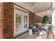 Cozy covered porch with comfortable seating next to the brick facade of the home at 108 Forrester Ave, Belmont, NC 28012