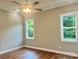 Bedroom featuring two windows, ceiling fan, hardwood floors, neutral paint and white trim at 1143 Journey Ln, Salisbury, NC 28146