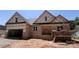New construction home featuring a brick exterior and an attached two-car garage at 1143 Journey Ln, Salisbury, NC 28146