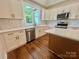 Bright kitchen features white cabinets, stainless steel appliances, white subway tile backsplash and hardwood floors at 1143 Journey Ln, Salisbury, NC 28146