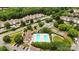 Aerial view of a community pool and tennis courts surrounded by mature trees and well-maintained landscaping at 11911 Ridgeway Park Dr, Charlotte, NC 28277