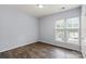 Bedroom with hardwood floors, natural light, and large window at 11911 Ridgeway Park Dr, Charlotte, NC 28277