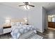 Bedroom with a large bed and nightstand with dark floors at 11911 Ridgeway Park Dr, Charlotte, NC 28277