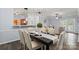 Dining area with dark wood table and view through the kitchen into the living room at 11911 Ridgeway Park Dr, Charlotte, NC 28277