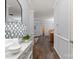Hallway with dark wood floors leading to a dining room and kitchen at 11911 Ridgeway Park Dr, Charlotte, NC 28277