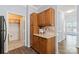 Kitchen area featuring wood cabinets and granite countertops with views to an adjacent pantry at 11911 Ridgeway Park Dr, Charlotte, NC 28277