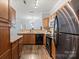 Kitchen with stainless steel appliances, wood cabinets and adjacent dining area at 11911 Ridgeway Park Dr, Charlotte, NC 28277