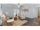Bright living room featuring hardwood floors, ceiling fan, and neutral color scheme at 11911 Ridgeway Park Dr, Charlotte, NC 28277