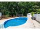 Backyard with an in-ground pool, wood deck, cabana and a small storage shed, surrounded by mature trees at 1197 Fincher Rd, Fort Lawn, SC 29714