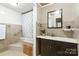 Bathroom features a walk-in tub with stylish shower curtain and tile, along with a vanity and mirror at 1197 Fincher Rd, Fort Lawn, SC 29714