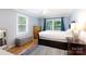 A bedroom featuring hard wood floors, a window with blue curtains, light grey walls and dark wood furniture at 1197 Fincher Rd, Fort Lawn, SC 29714
