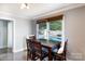 Bright dining area with seating for four, complemented by views of the sparkling pool outside the window at 1197 Fincher Rd, Fort Lawn, SC 29714
