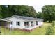 Charming one-story home featuring a spacious porch with outdoor seating and a classic white facade at 1197 Fincher Rd, Fort Lawn, SC 29714
