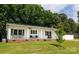 Charming single story home featuring a brick foundation, white siding, covered porch and a lush lawn at 1197 Fincher Rd, Fort Lawn, SC 29714