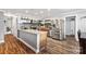 An updated kitchen featuring stainless steel appliances, mosaic backsplash, tile floors and a large granite island at 1197 Fincher Rd, Fort Lawn, SC 29714