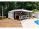 Pool house with outdoor kitchen, seating area, and view of the backyard at 1197 Fincher Rd, Fort Lawn, SC 29714