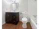 Updated bathroom with dark wood vanity, white fixtures, and wood-look flooring at 1224 Bethlehem Rd, Kings Mountain, NC 28086