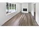 Bright living room featuring wood floors, large windows, and a white brick fireplace at 1224 Bethlehem Rd, Kings Mountain, NC 28086