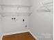 Utility room features wire shelving, laminate floors, and washer dryer hookups at 1224 Bethlehem Rd, Kings Mountain, NC 28086