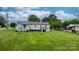 Residential home with a spacious backyard and deck with blue door at 1266 18Th Ne St, Hickory, NC 28601
