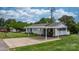 Inviting single-story home boasts a carport, lush green lawn, and classic design at 1266 18Th Ne St, Hickory, NC 28601