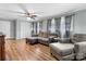 Spacious living room with gray sofa and chairs, wood-look flooring and ceiling fan at 1266 18Th Ne St, Hickory, NC 28601